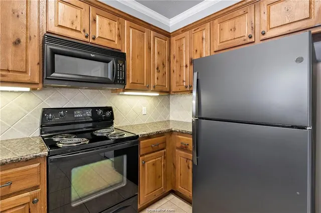 a kitchen with granite countertop cabinets and steel stainless steel appliances