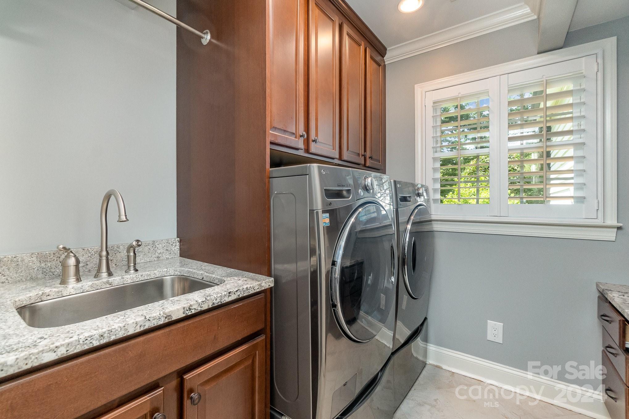 1008 Dumbarton Road Gastonia, NC 28054 - Photo 15 of 39 a utility room with stainless steel appliances granite countertop a sink a washer and dryer next to a window