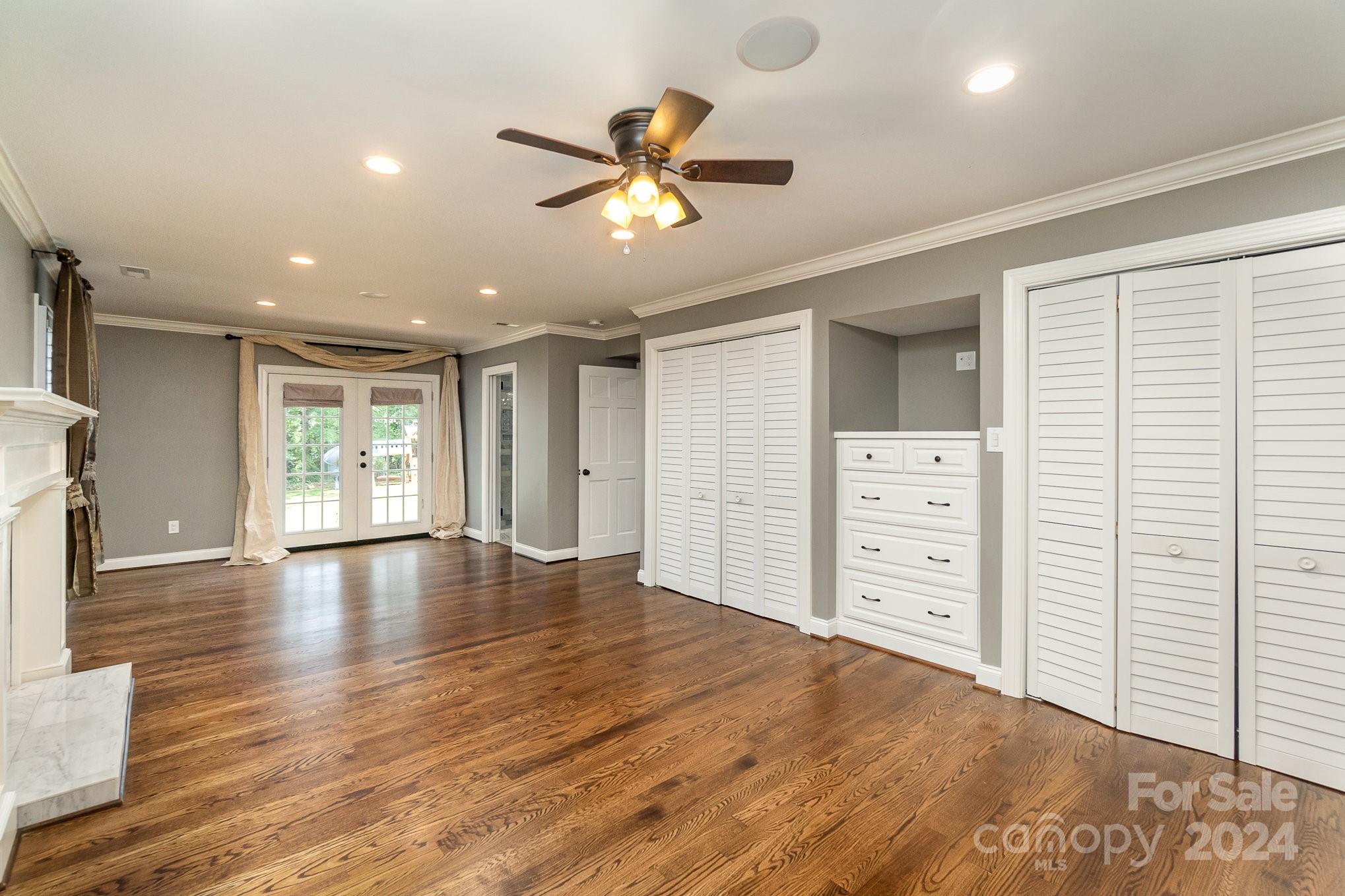 1008 Dumbarton Road Gastonia, NC 28054 - Photo 18 of 39 a view of a livingroom with a hardwood floor and a ceiling fan