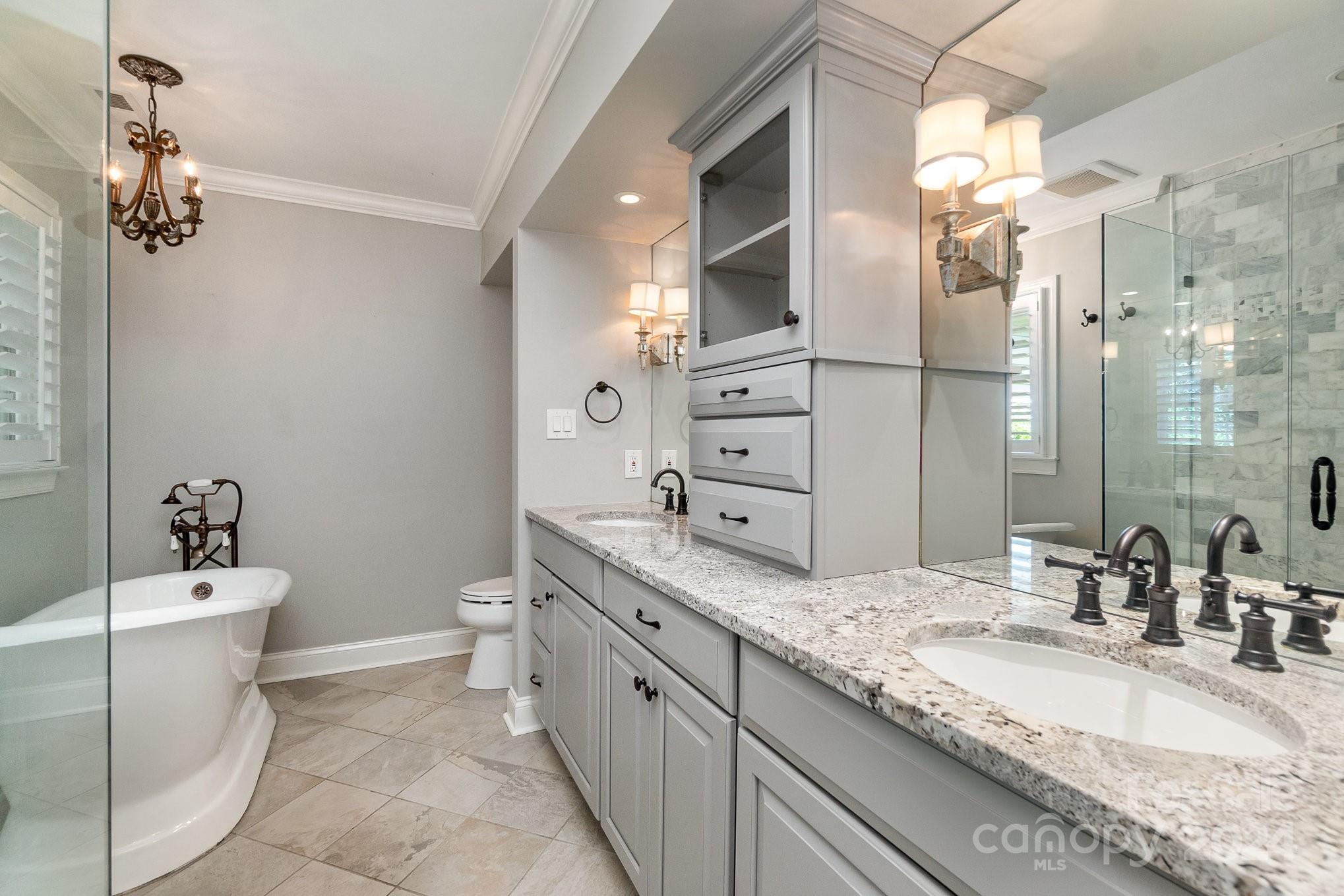 1008 Dumbarton Road Gastonia, NC 28054 - Photo 20 of 39 a bathroom with a granite countertop sink a toilet and shower