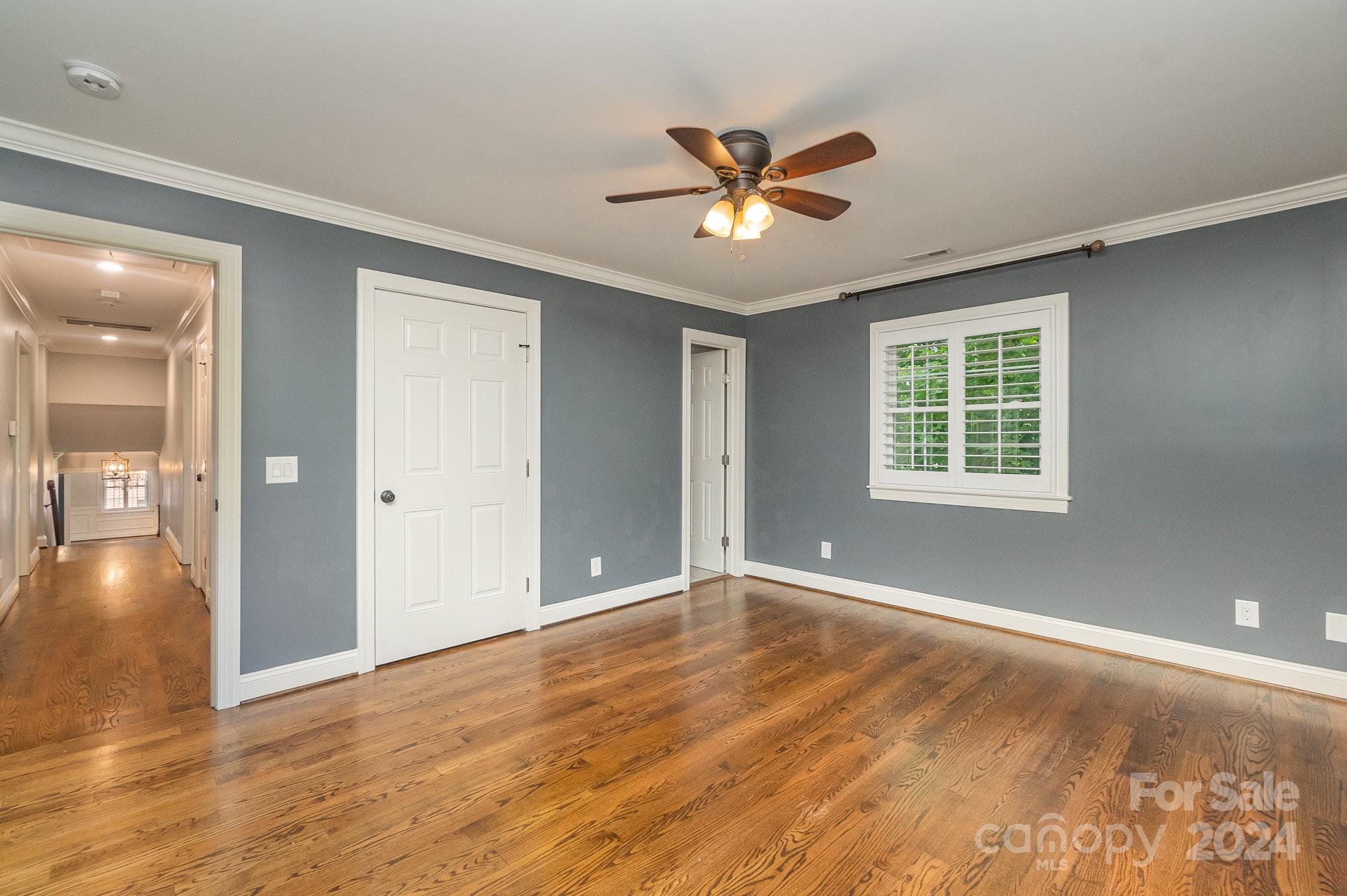 1008 Dumbarton Road Gastonia, NC 28054 - Photo 22 of 39 a view of an empty room with window and wooden floor