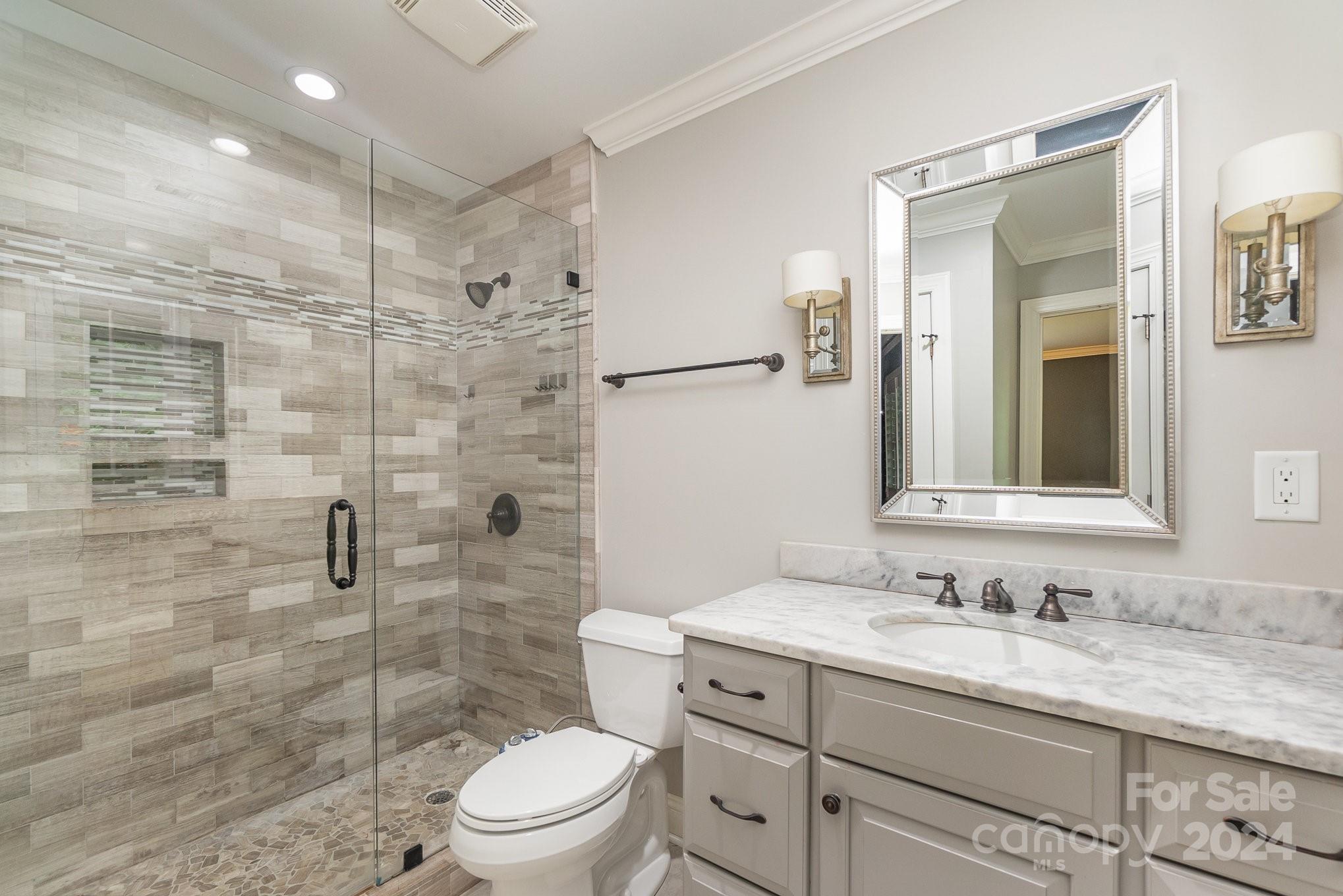 1008 Dumbarton Road Gastonia, NC 28054 - Photo 23 of 39 a bathroom with a granite countertop sink toilet a mirror and shower