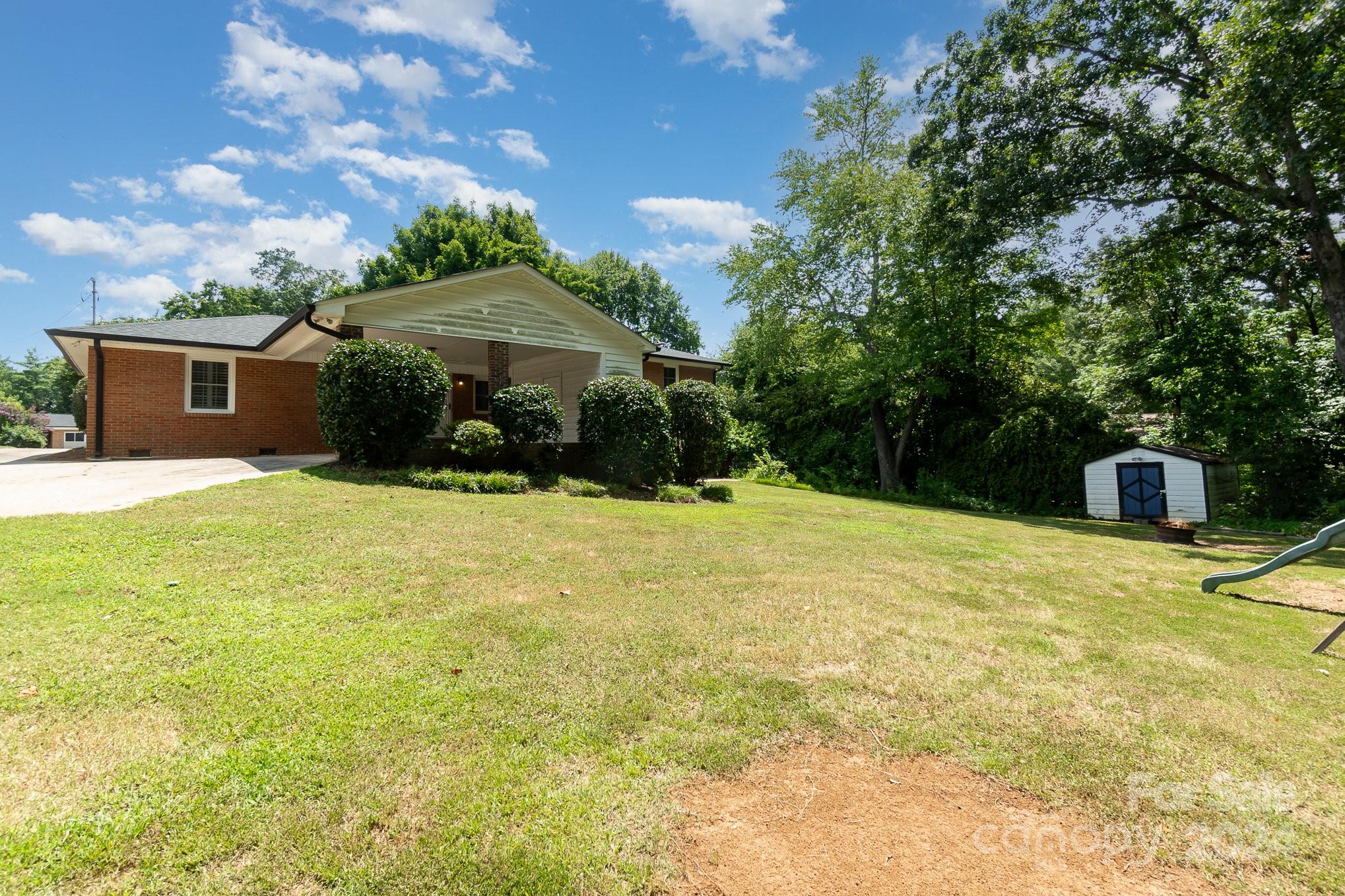 1008 Dumbarton Road Gastonia, NC 28054 - Photo 35 of 39 a swimming pool with outdoor seating and yard