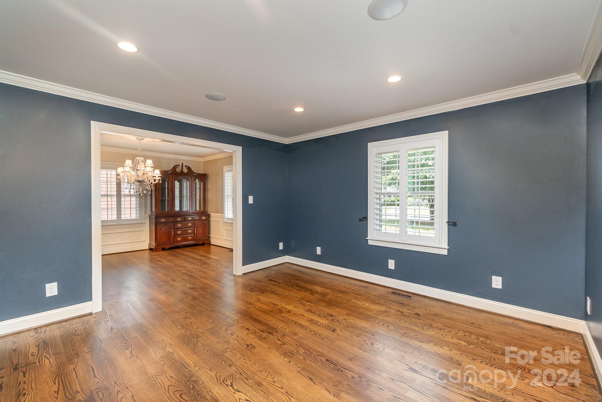 1008 Dumbarton Road Gastonia, NC 28054 - Photo 4 of 39 a view of an empty room with a window and wooden floor