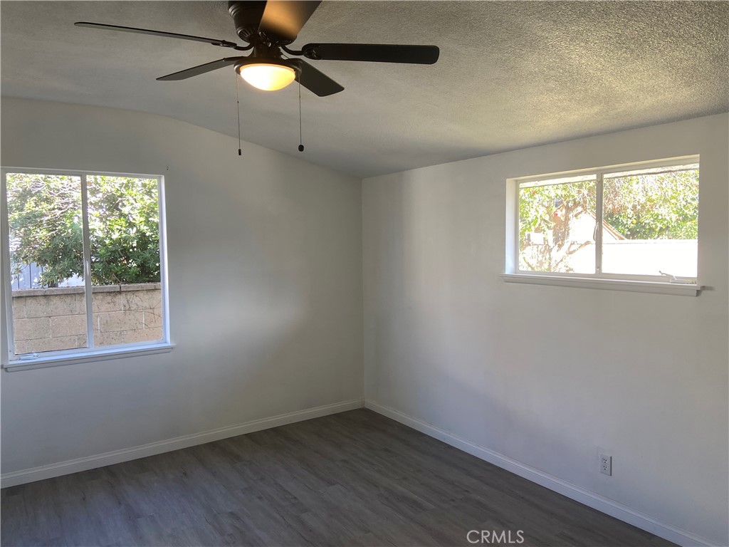 856 Altura Way Upland, CA 91786 - Photo 20 of 33 an empty room with a window and a fan
