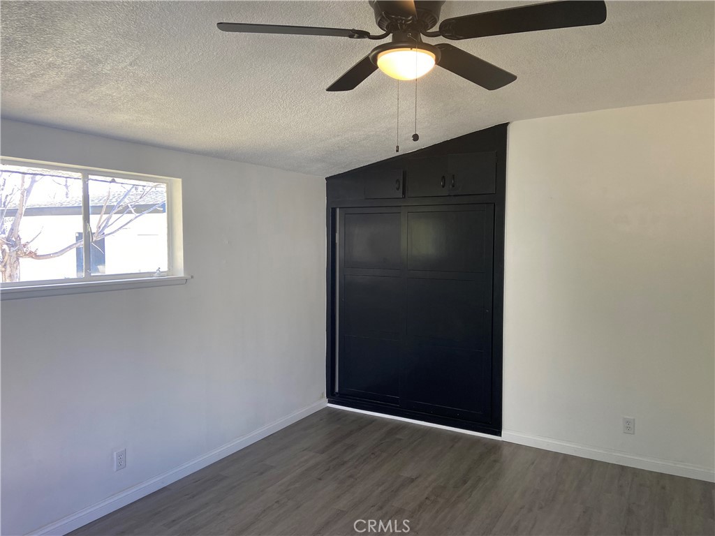 856 Altura Way Upland, CA 91786 - Photo 22 of 33 an empty room with wooden floor closet and fan