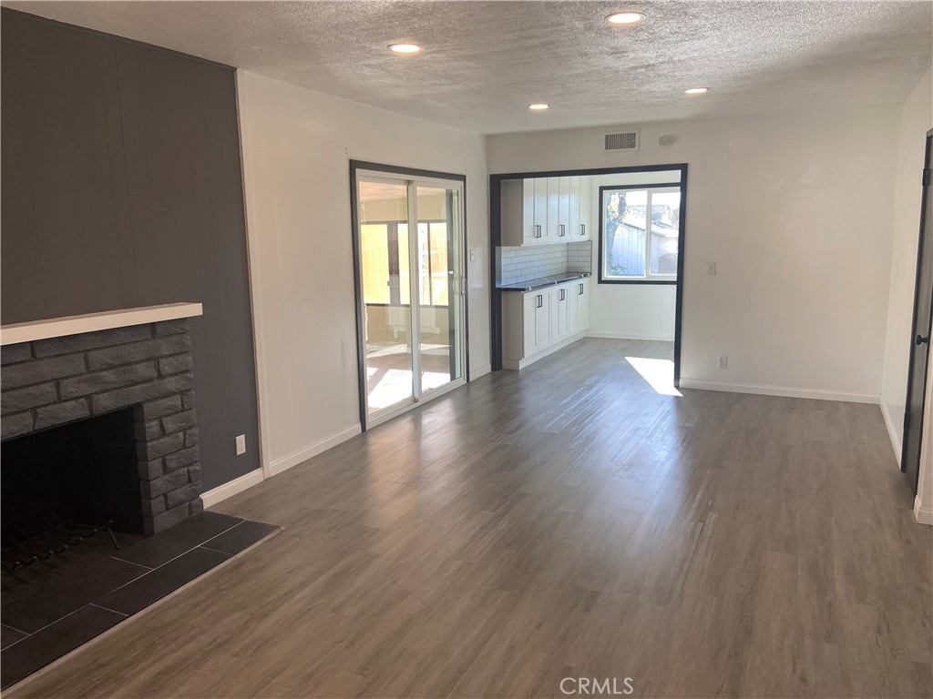 856 Altura Way Upland, CA 91786 - Photo 9 of 33 a view of an empty room with window and wooden floor