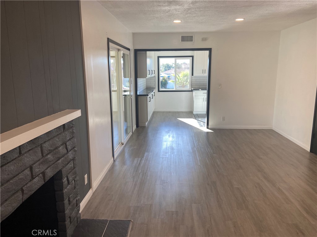 856 Altura Way Upland, CA 91786 - Photo 10 of 33 a view of a hallway with wooden floor and a kitchen