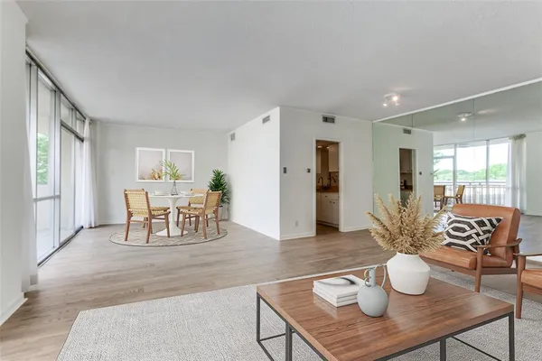 a dining room with furniture and wooden floor