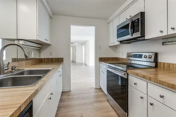 a kitchen with stainless steel appliances granite countertop a sink and a stove