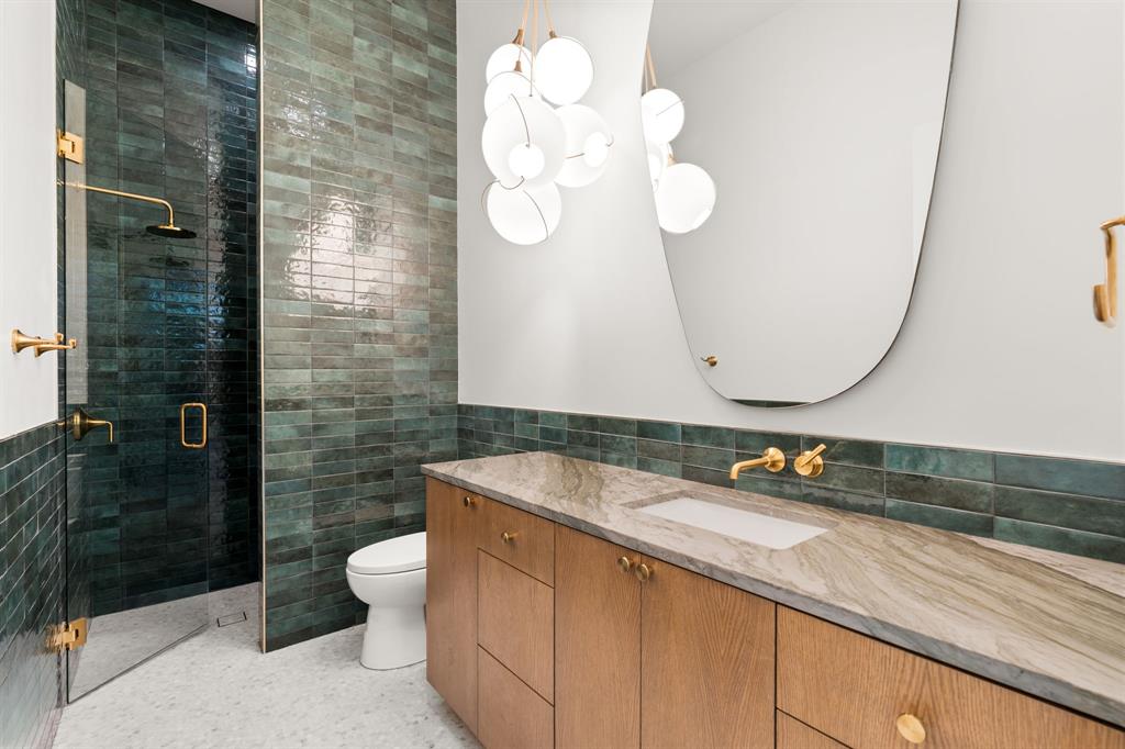 5908 Bull Creek Road Austin, TX 78757 - Photo 22 of 36 Guest full bathroom on the main floor with rich hues and a dramatic light fixture.