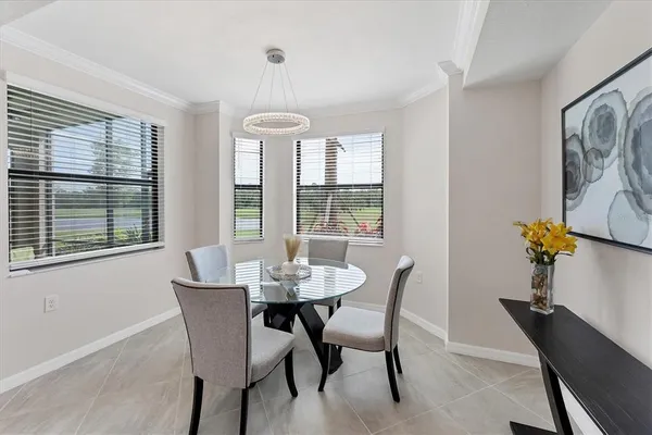 a view of a dining room with furniture and window