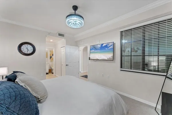 a bedroom with a bed and a large mirror