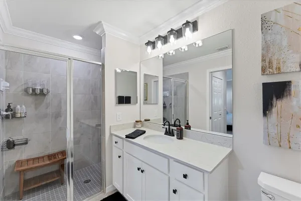 a bathroom with a double vanity sink mirror and shower