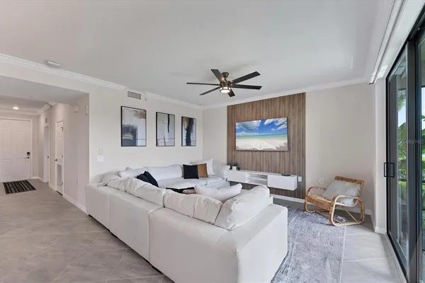 a living room with furniture and a ceiling fan