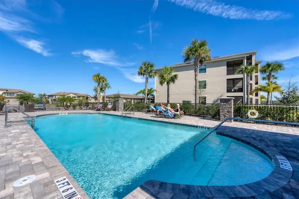 a swimming pool with outdoor seating and yard