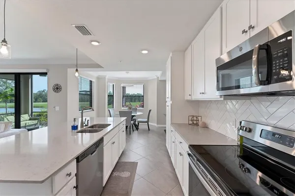 a kitchen with stainless steel appliances a stove sink microwave and cabinets