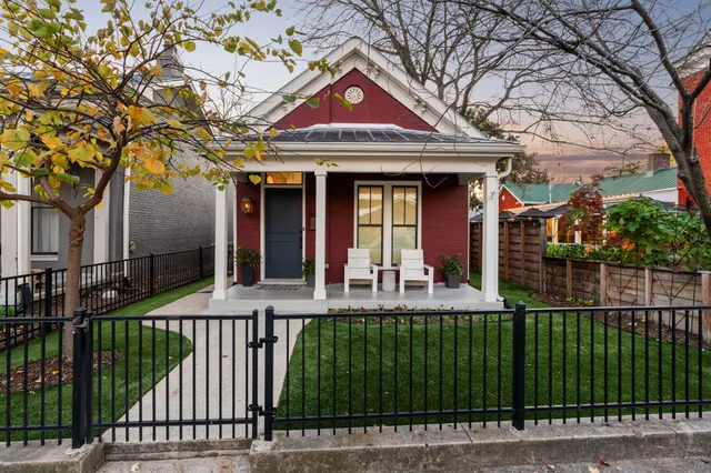 a front view of a house with a garden and plants
