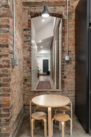 a bathroom with a granite countertop sink a mirror and a toilet