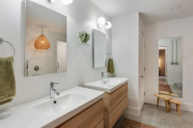 a bathroom with a sink a mirror a bathtub and shower