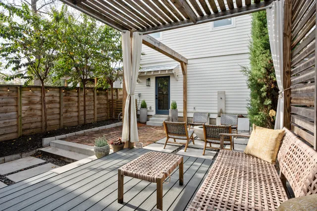 a view of a patio with iron fence