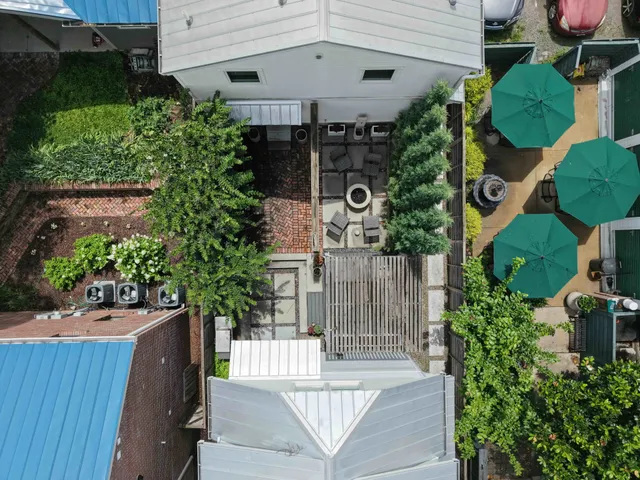 a front view of a house with a garden and plants