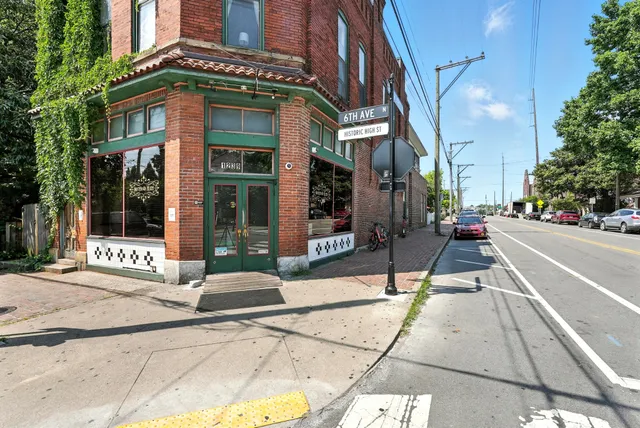 a view of a house with backyard and sitting area