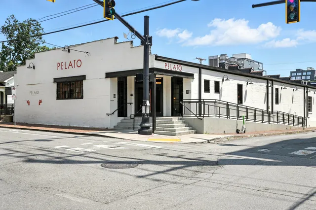 a view of a house with a flower plants next to a road