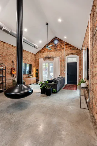 a living room with furniture a fireplace and a flat screen tv