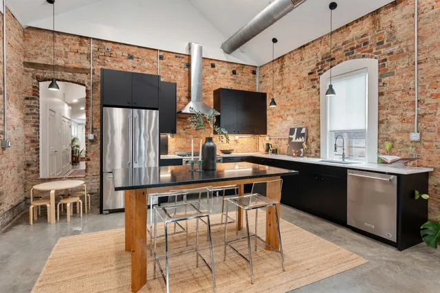 a kitchen with stainless steel appliances a microwave a sink and cabinets