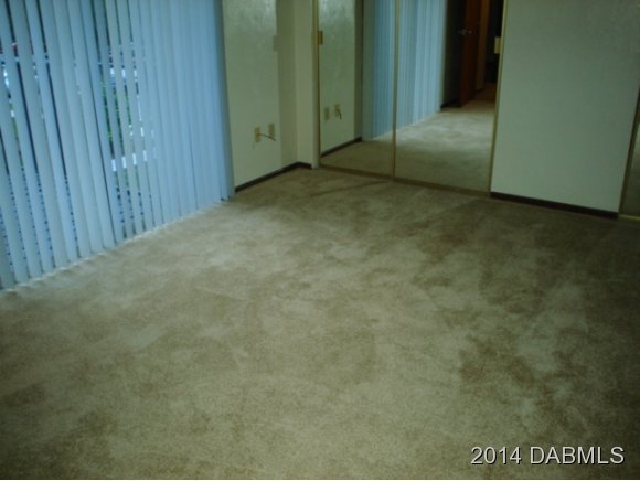75 Springwood Square Port Orange, FL 32129 - Photo 5 of 6 a view of an empty room with wooden door