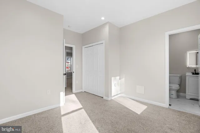 a view of livingroom with hallway and a bathroom