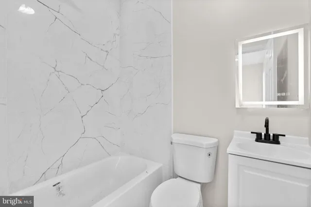 a bathroom with a toilet and a sink