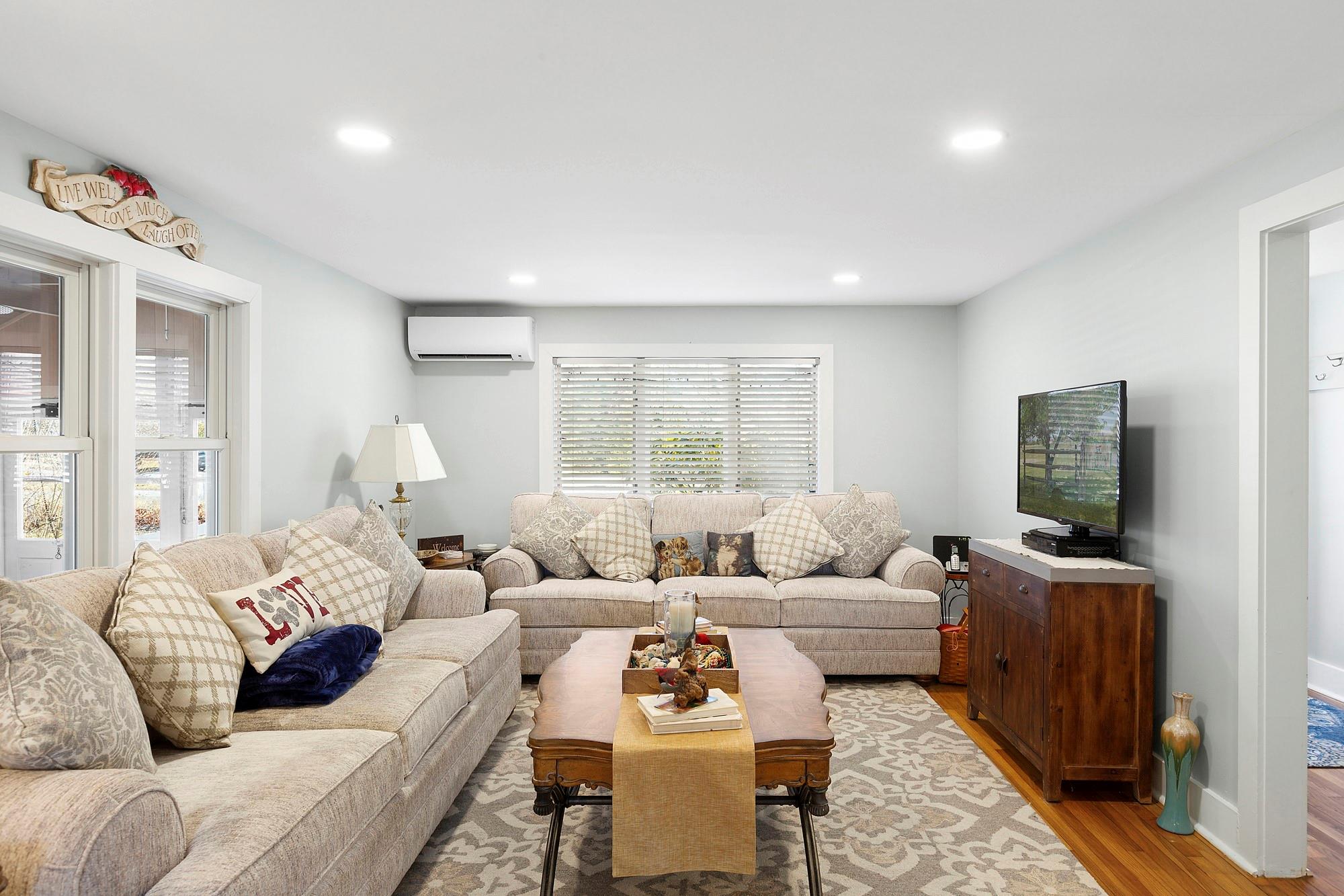 20 Mitchell Road Westhampton Beach, NY 11978 - Photo 6 of 16 a living room with furniture and a flat screen tv