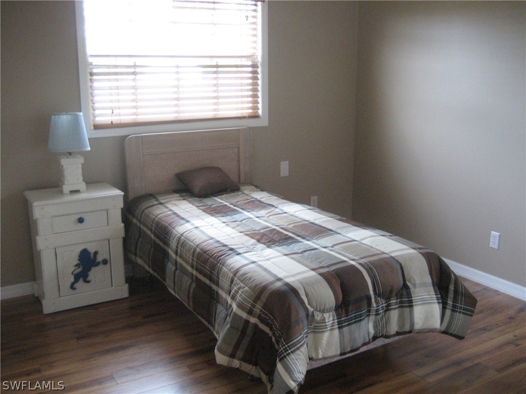 18461 Geranium Road Fort Myers, FL 33967 - Photo 13 of 17 a bedroom with a bed and window