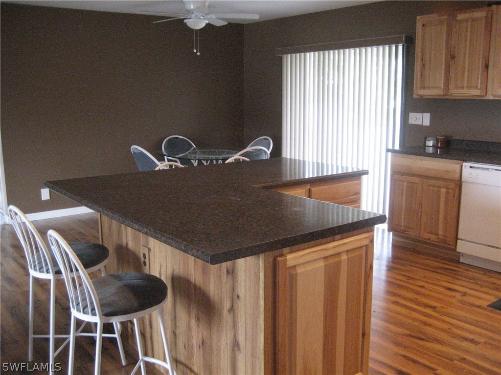 18461 Geranium Road Fort Myers, FL 33967 - Photo 3 of 17 a kitchen with a table chairs and wooden floor