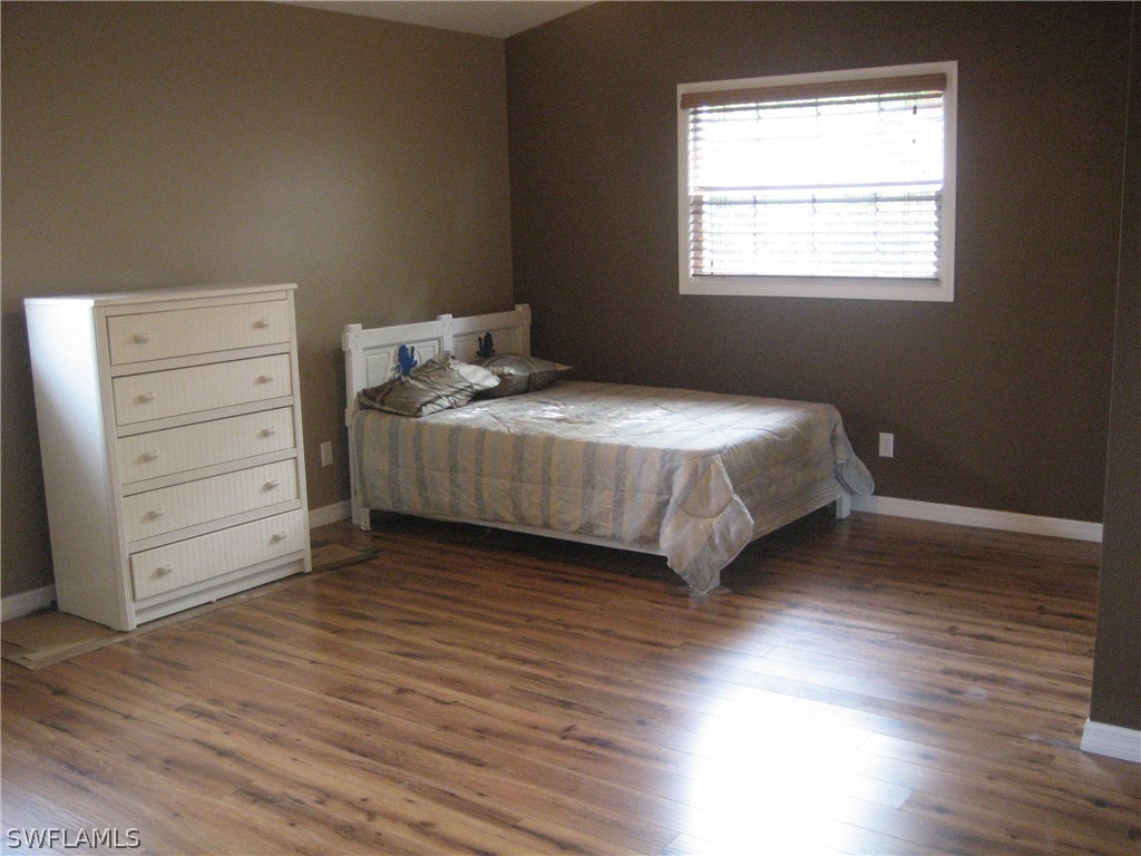 18461 Geranium Road Fort Myers, FL 33967 - Photo 5 of 17 a bedroom with a bed and a window