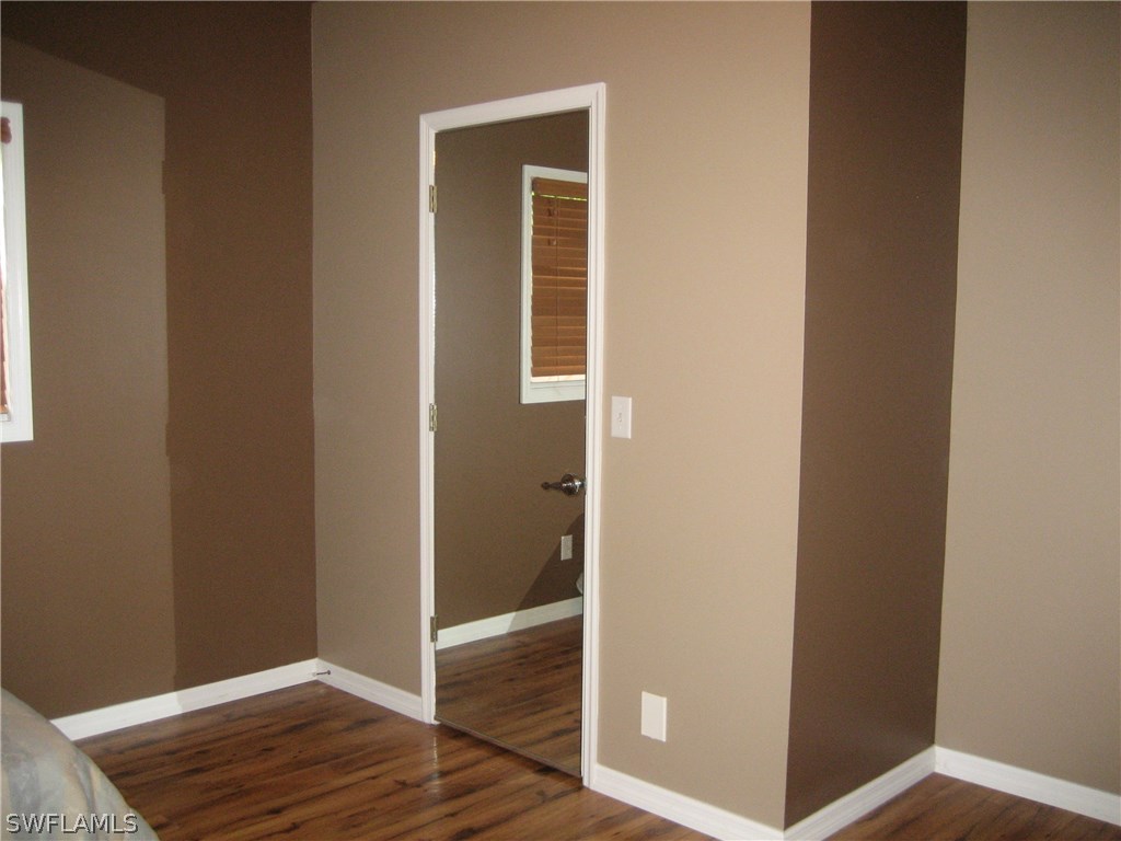 18461 Geranium Road Fort Myers, FL 33967 - Photo 6 of 17 a view of a hallway with wooden floor