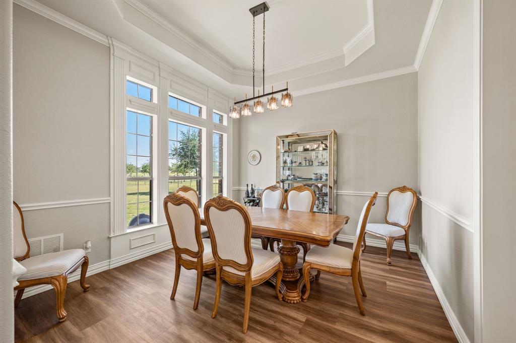 1216 W Road Waxahachie, TX 75165 - Photo 5 of 40 a dining room with furniture a chandelier and wooden floor