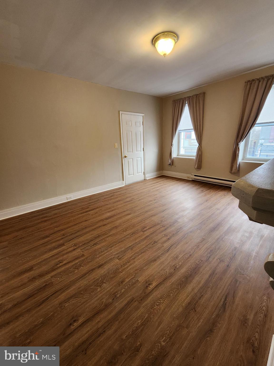 10 North Main Street, Unit 4 Union Bridge, MD 21791 - Photo 6 of 9 an empty room with wooden floor and windows