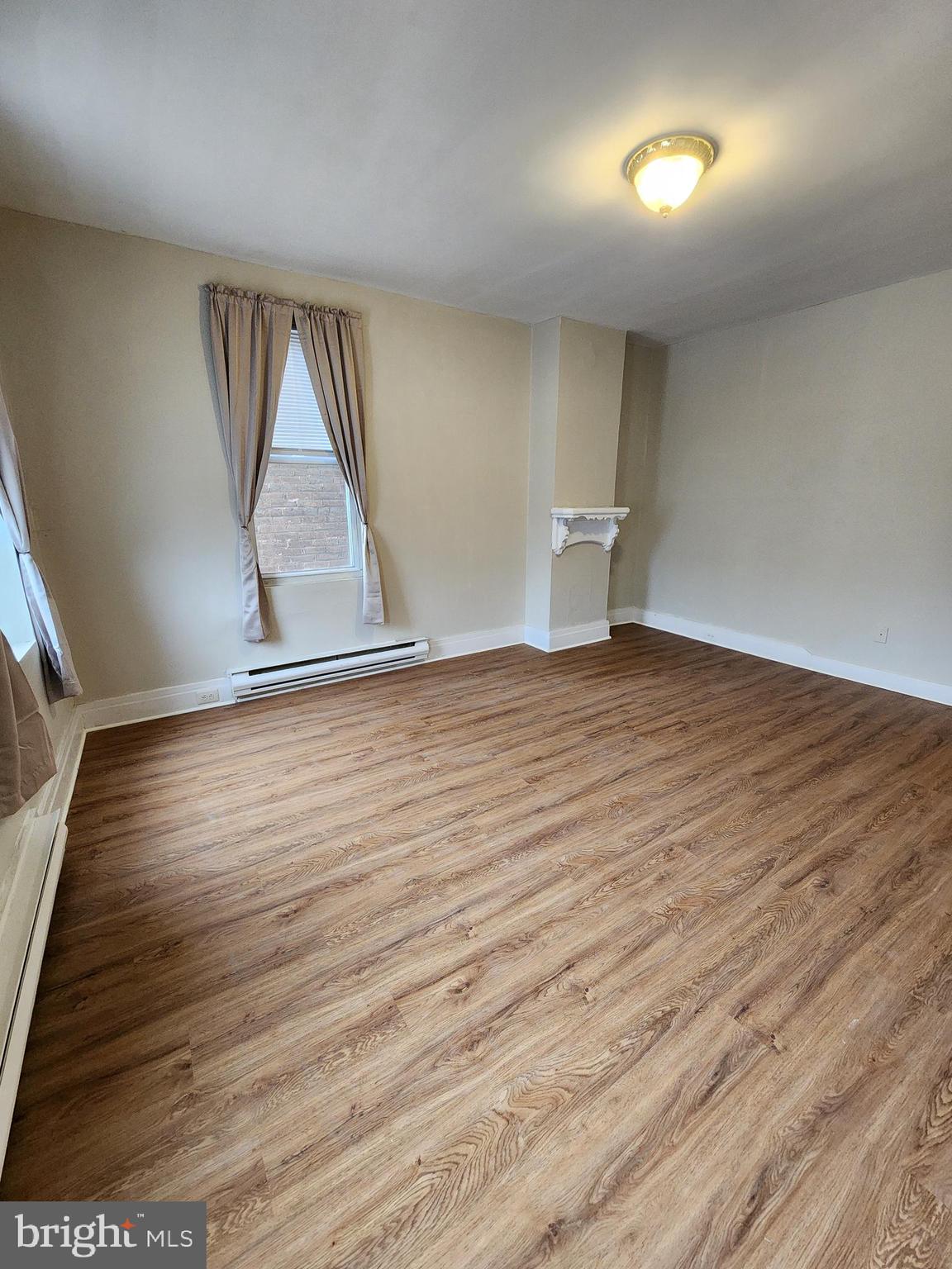 10 North Main Street, Unit 4 Union Bridge, MD 21791 - Photo 7 of 9 wooden floor in an empty room with a window