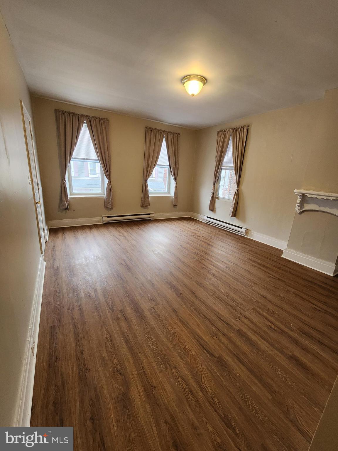 10 North Main Street, Unit 4 Union Bridge, MD 21791 - Photo 8 of 9 an empty room with wooden floor and windows