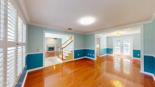 a bedroom with a bed and large windows