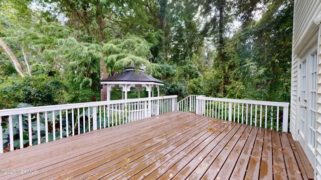 a view of balcony with wooden floor and fence