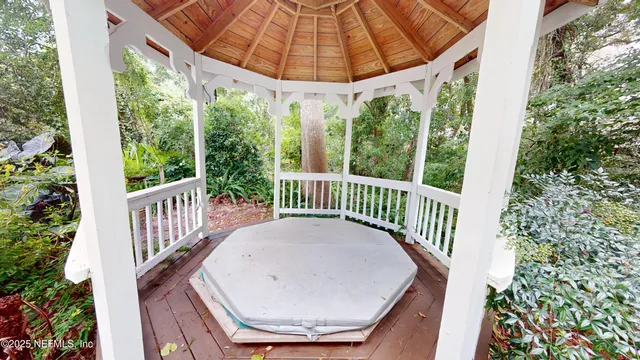 a view of a balcony with a table and chairs