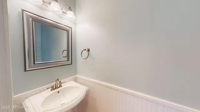 a bathroom with a sink and mirror
