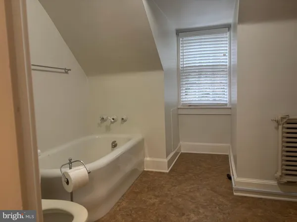a bathroom with a tub and shower