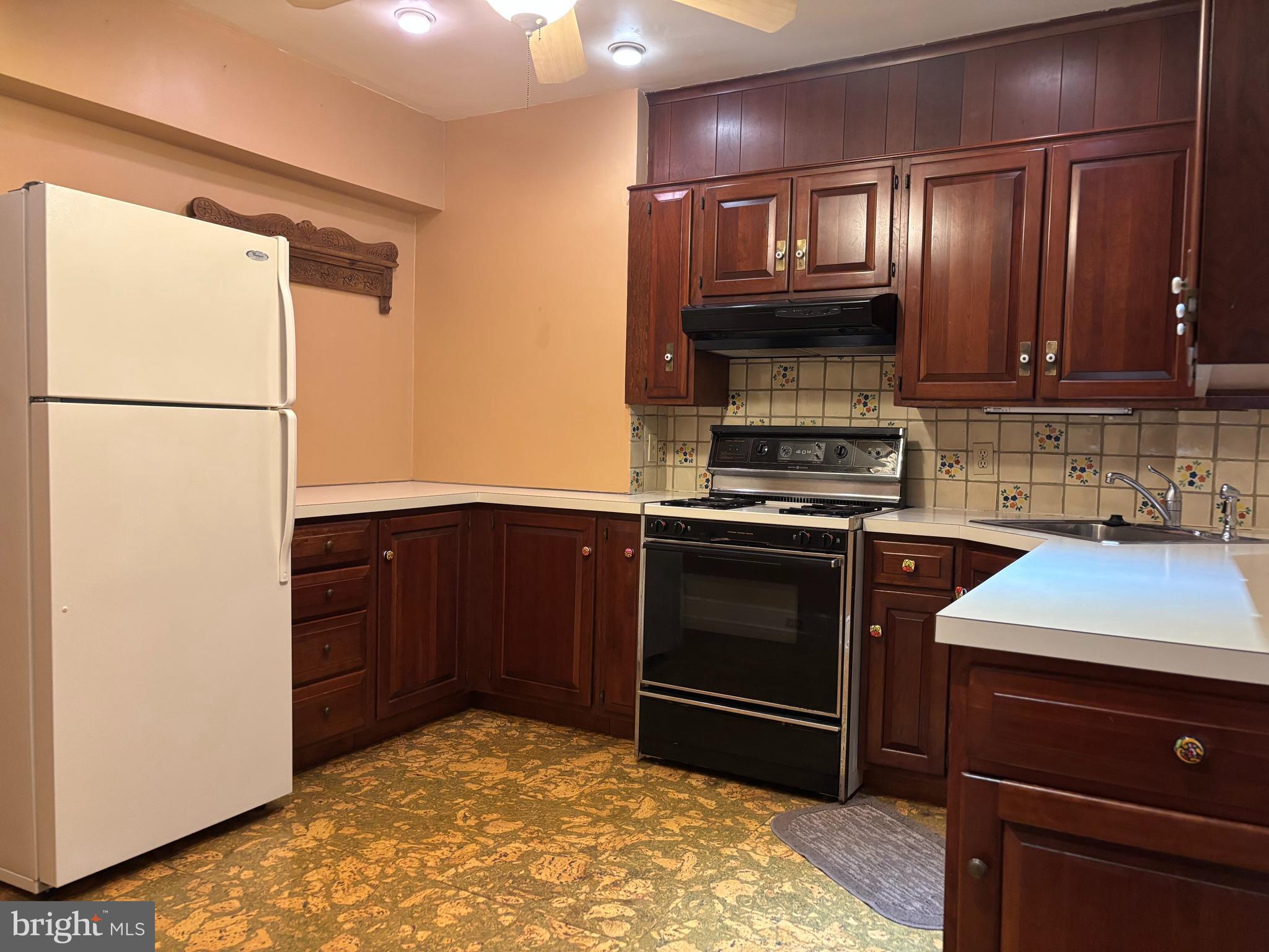 1121 Spring Grove Avenue Lancaster, PA 17603 - Photo 8 of 23 a kitchen with granite countertop stainless steel appliances and wooden cabinets