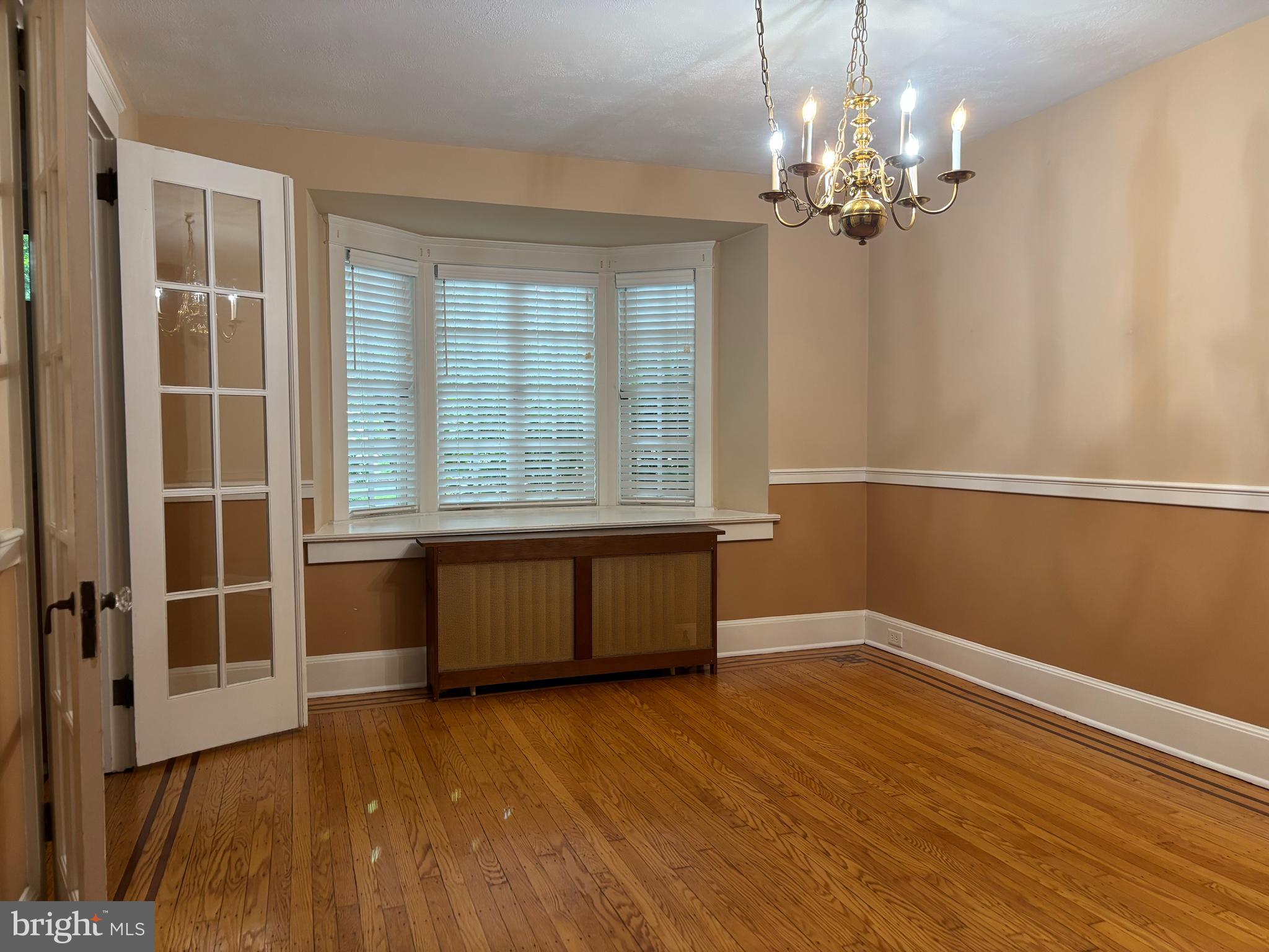 1121 Spring Grove Avenue Lancaster, PA 17603 - Photo 8 of 25 a view of an empty room with wooden floor and a window