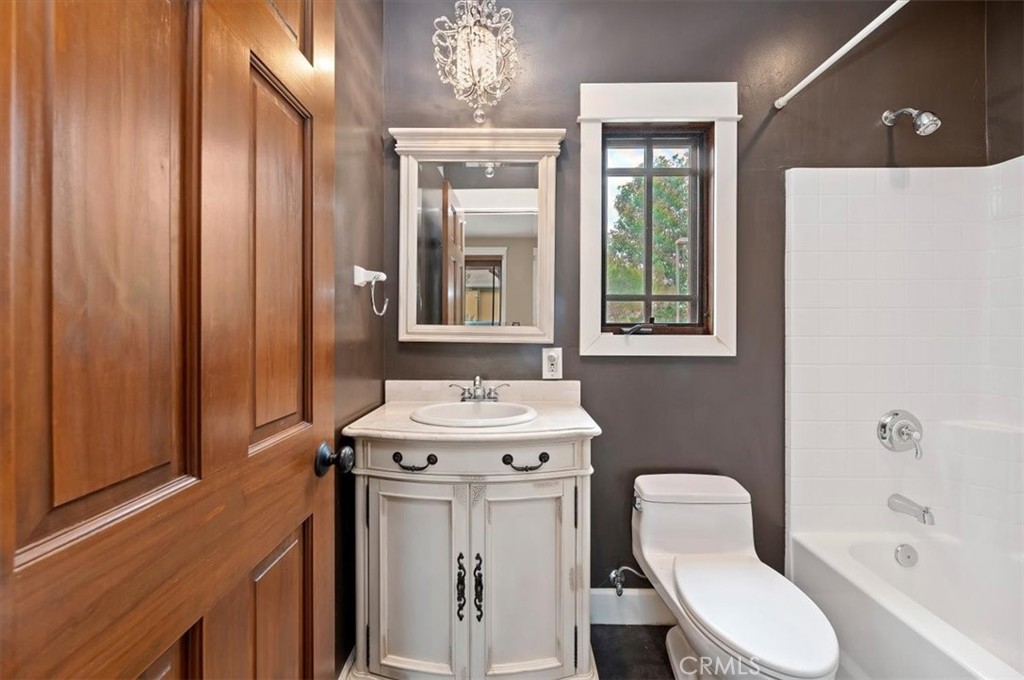16420 Rocky Glen Road Perris, CA 92570 - Photo 38 of 74 a bathroom with a toilet a sink and a mirror